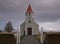 A peat wall in front of a small church in Iceland