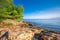 Pebble beach on Brac island with turquoise clear ocean water, Supetar, Brac, Croatia