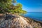 Pebble beach on Brac island with turquoise clear ocean water, Supetar, Brac, Croatia