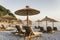 Pebble beach with hammocks and umbrellas at sunset in Jaz Beach, Montenegro