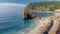 Pebble beach Monterosso Chairs and umbrellas on the beach of Cinque Terre Italy.