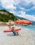 Pebble beach Monterosso vacation Chairs and umbrellas on the beach of Cinque Terre Italy.