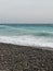 Pebble beach of Nice, France with azure waves of mediterranean sea