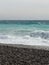 Pebble beach of Nice, France with azure waves of mediterranean sea