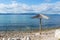 Pebble beach with straw parasol