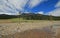 Pebble Creek under cumulus cirrus cloud skies at the east end of the Lamar Valley in Yellowstone National Park in Wyoming