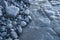 Pebble of different sizes and exposed rock in low tide in Cantabrian beach