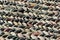 Pebble pavement pattern closeup. Stone mosaic background. Focus