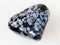 pebble of snowflake obsidian gem stone on white