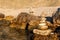 Pebble stack on the seashore. Pyramid of stones on the beach. Light at sunset. Symbol of patience. Concept of harmony and balance.