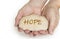 Pebble stone in hands. Concept for a hope sign