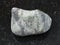 pebble of Suevite stone on dark background