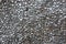 Pebble wall texture background painted with metallic gray paint