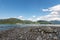 Pebbled Shoreline of Tegernsee with Alpine View