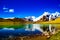 Pebbles on a ake shore with blue skies reflecting on still blue waters. scenic himalayan landscape