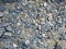 Pebbles concrete rock stone floor background texture in blue and grey colour on the sand