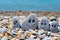 Pebbles with drawn faces in the sand. Father, mother, daughter and son. Family vocation concept