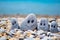 Pebbles with drawn faces in the sand. Father, mother, daughter and son. Family vocation concept