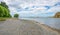 Pebbles on Hurunui River Mouth under blue cloudy sky in South Island, New Zealand