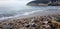 Pebbles among the sand on seashore