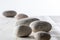 Pebbles set on white wooden background for mindfulness or yoga