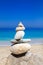 Pebbles stack balance over blue ionian sea