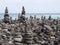 Pebbles and stones arranged into many tall stacked shapes