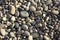 Pebbly gray beach stones texture background