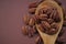 Pecan nut in spoon on bright brown background.Healthy fats.Heap shelled Pecans nut closeup. Ingredient of the keto diet