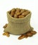 Pecan nuts in linen sack on white background.