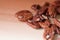 Pecan nuts are scattered on a wooden surface close-up. Healthy food background, brown color toned