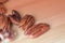 Pecan nuts are scattered on a wooden surface close-up. Healthy food background, brown color toned