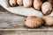 Pecan nuts on wooden table with pecans in gunny sack background