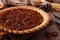 Pecan pie, close up table scene with a wood background
