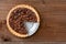 A Pecan pie with a slice cut out. Horizontal format on a rustic wood table with copy space