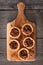 Pecan pie tarts on a wooden paddle board