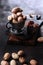 Pecans in a metal cup on a wooden board. Expensive walnut. Natural protein. Vertical photo. Smoke in the background