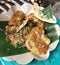 Pecel rice with fried chicken topping and peanut brittle and bakwan