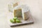 Pecorino cheese on wooden table with cut green zebra tomatoes