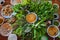 Peculiar herbs salad in Kon Tum, Vietnam. Using the leaves to make a cone-shaped container to put the food in, and use some bacon,