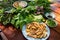 Peculiar herbs salad in Kon Tum, Vietnam. Using the leaves to make a cone-shaped container to put the food in, and use some bacon,