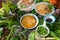 Peculiar herbs salad in Kon Tum, Vietnam. Using the leaves to make a cone-shaped container to put the food in, and use some bacon,