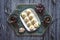 Peda Indian sweet, Milk Fudge with tea cups in a dark wooden table. Top view