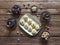 Peda Indian sweet, Milk Fudge with tea cups and dates in a dark wooden table. Top view