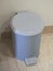 Pedal bin Placed on a soft wooden floor The walls are white cement