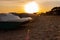 Pedal boats on the sunset on a tropical island beach. Colorful catamaran on an empty sea shore on evening landscape