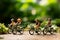 Pedaling joy Miniature people on bicycles with a green bokeh backdrop