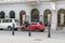 pedaling past a cyclist overtakes a red car on a vienna street