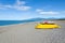 Pedalos and kayaks on a gravel beach