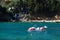 PedalÃ² moored in the sea in front of a diving center, on the bottom there are some people on the